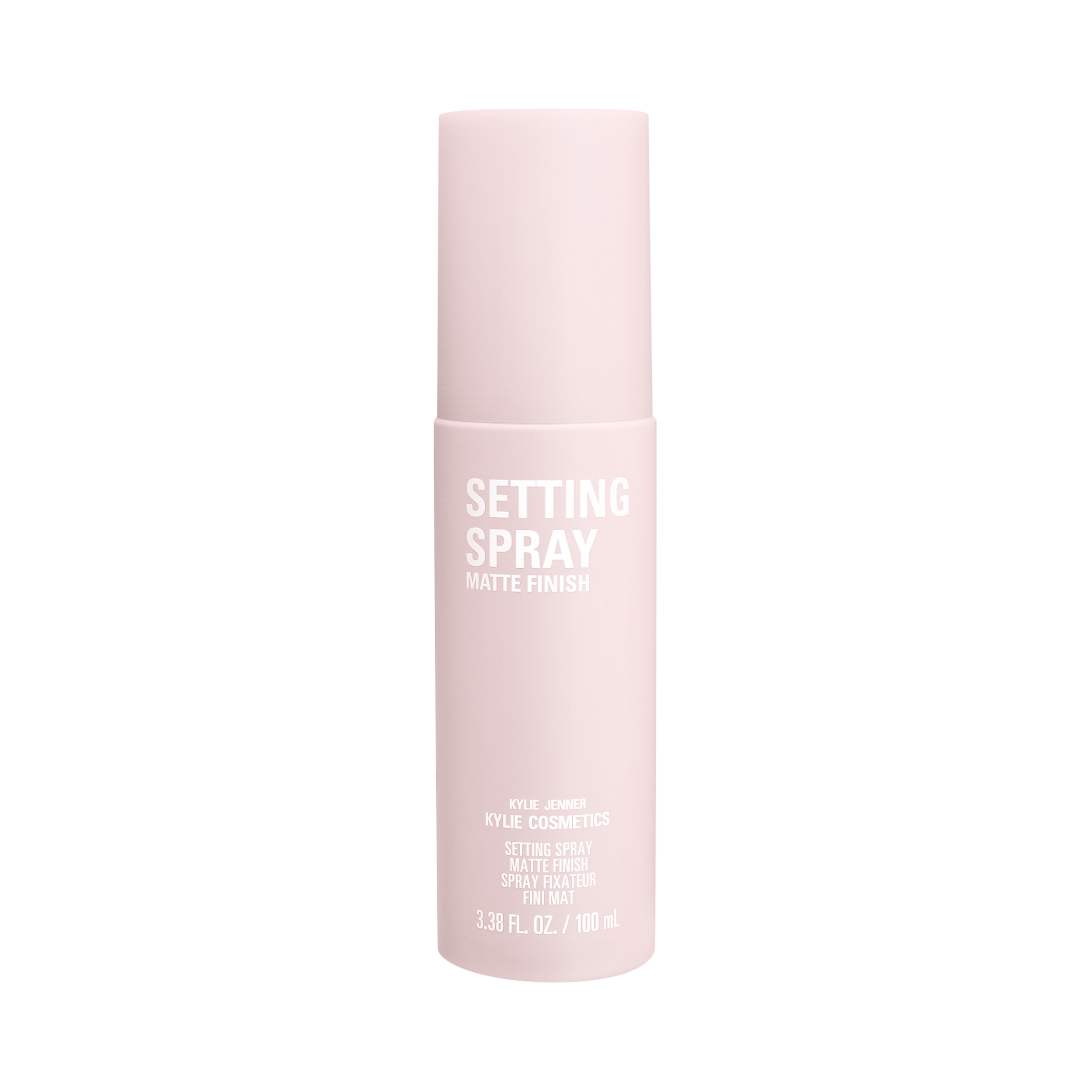 Pale pink matte finish setting spray bottle with white lettering on a white background, for Kylie Cosmetics.